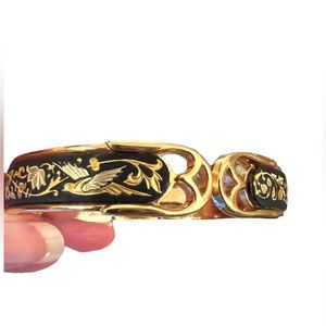 Gold toned cuff bracelet with black inlay